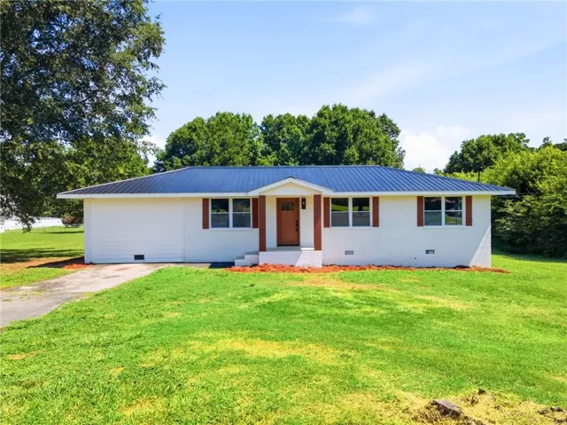White exterior with a dark blue metal roof