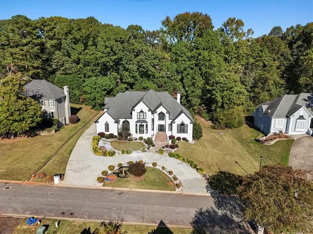 Aerial view of property and surrounding area featuring a heavily wooded area