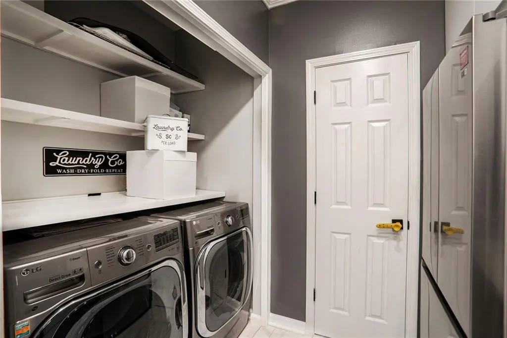 Washroom featuring washing machine and dryer