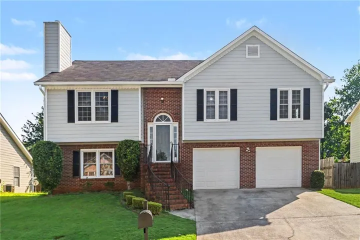 Brick and siding exterior with a two-car garage