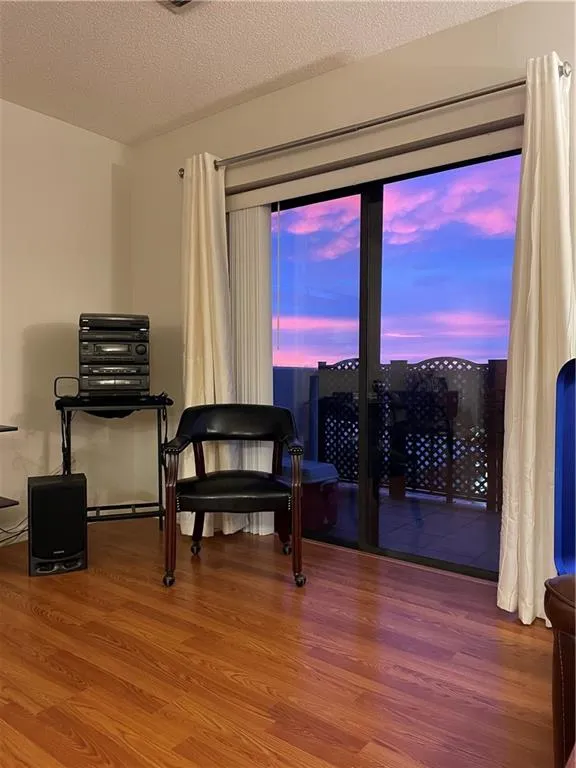 Living room featuring light wood-style flooring and baseboards