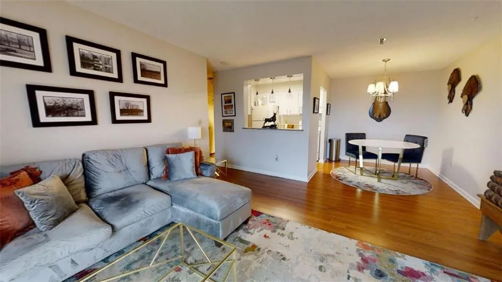 Living room featuring wood finished floors and suspended lighting