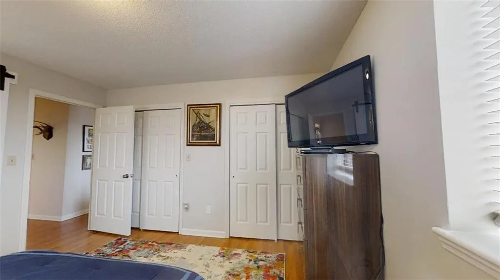 Bedroom with two closets and light wood-style floors