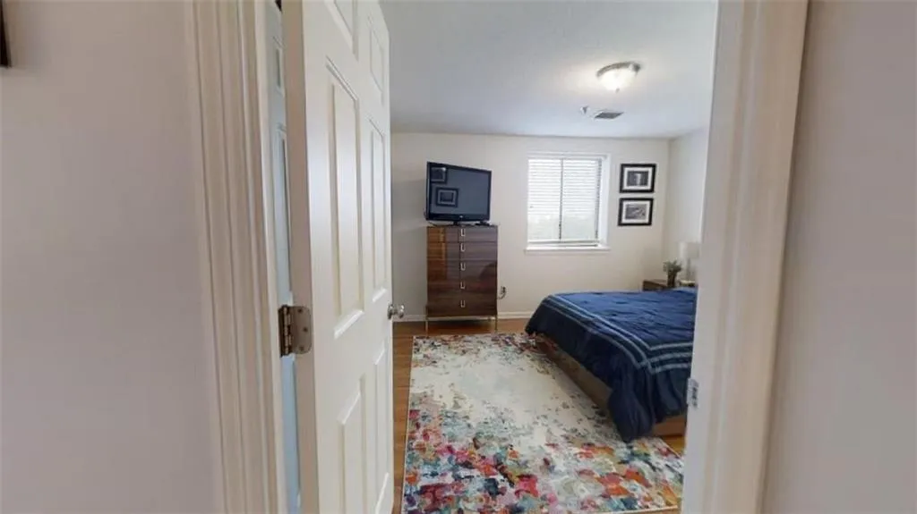 Bedroom with wood finished floors and baseboards