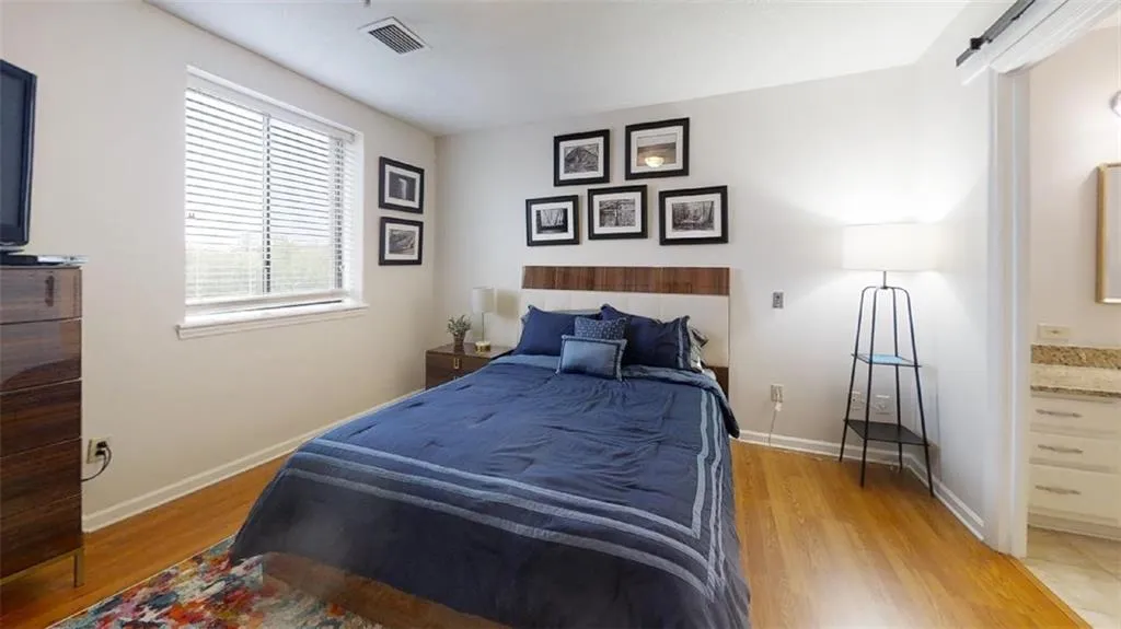 Bedroom featuring light wood finished floors and baseboards