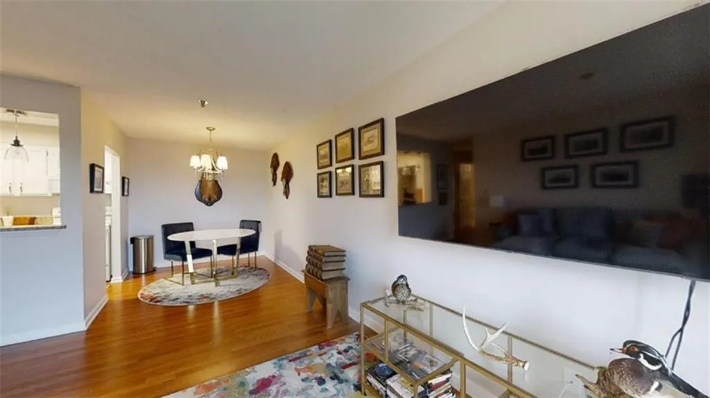 Living room featuring wood finished floors and hanging lights