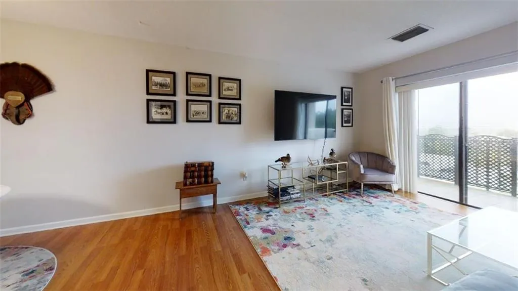 Living area featuring a textured ceiling, wood finished floors, and a city view
