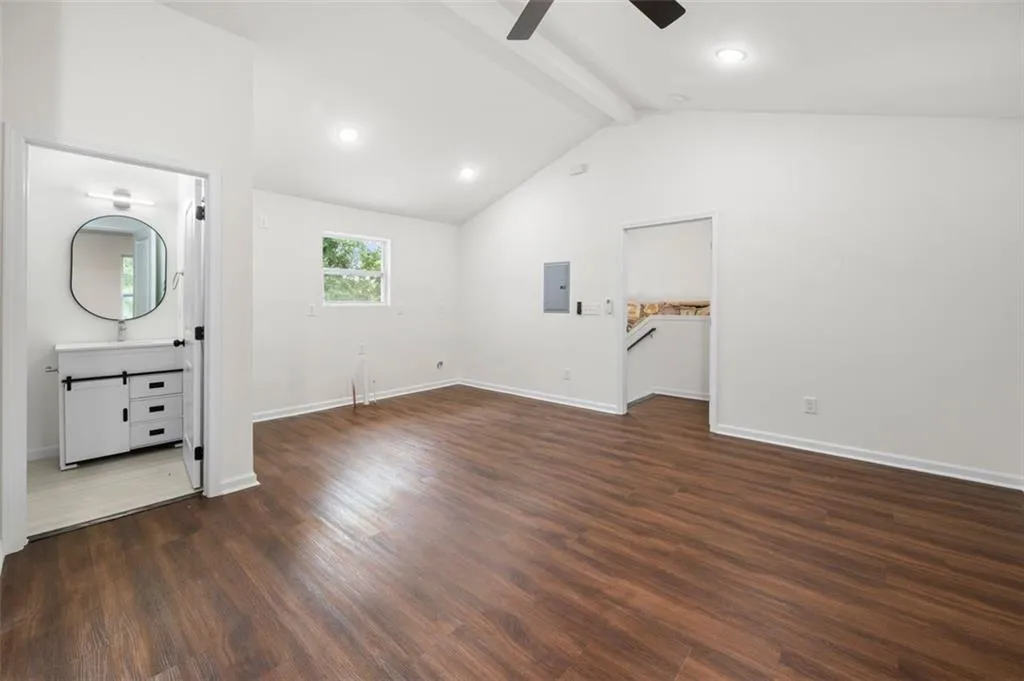Unfurnished bedroom with dark wood-style flooring, a ceiling fan, recessed lighting, electric panel, and ensuite bathroom