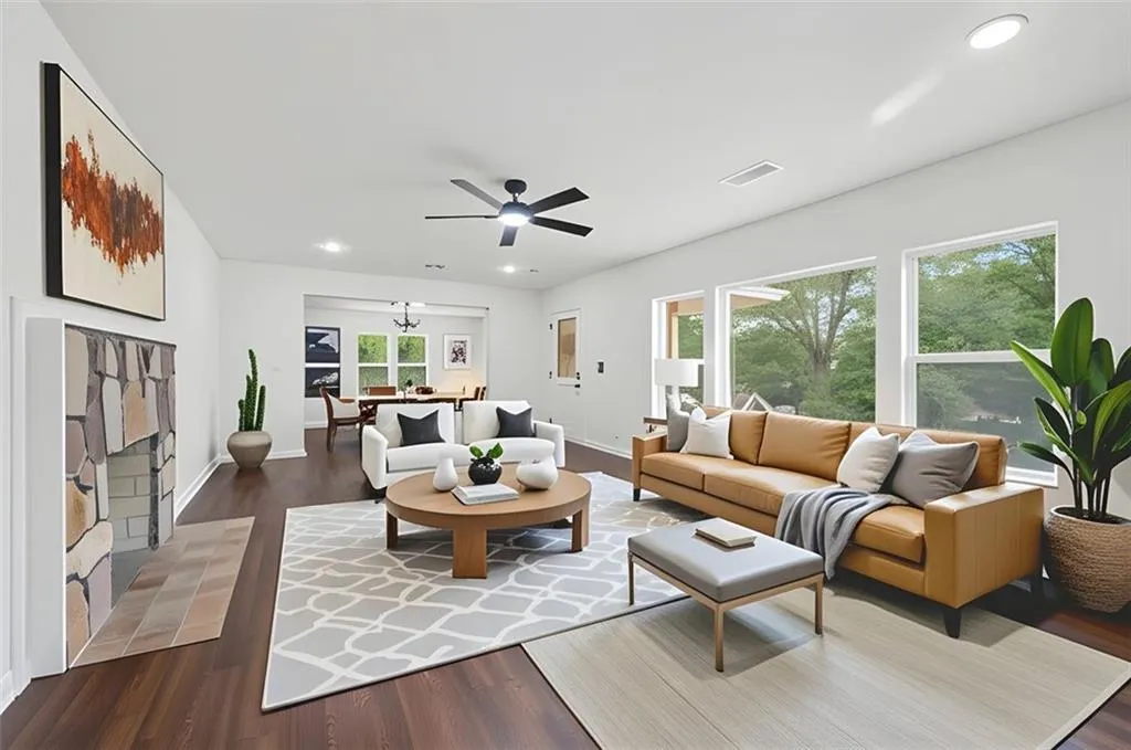 Living room featuring dark wood-type flooring, recessed lighting, and ceiling fan