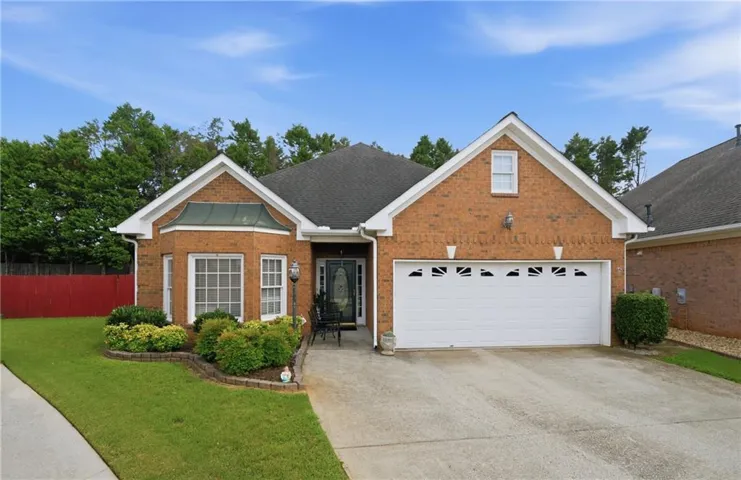 Brick exterior with a prominent two-car garage