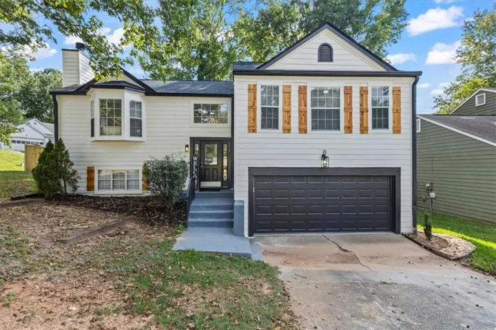 Light-colored siding exterior with dark trim accents