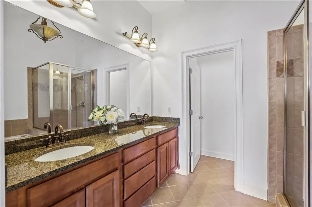 Primary Bathroom with double vanity, standing shower and a tub