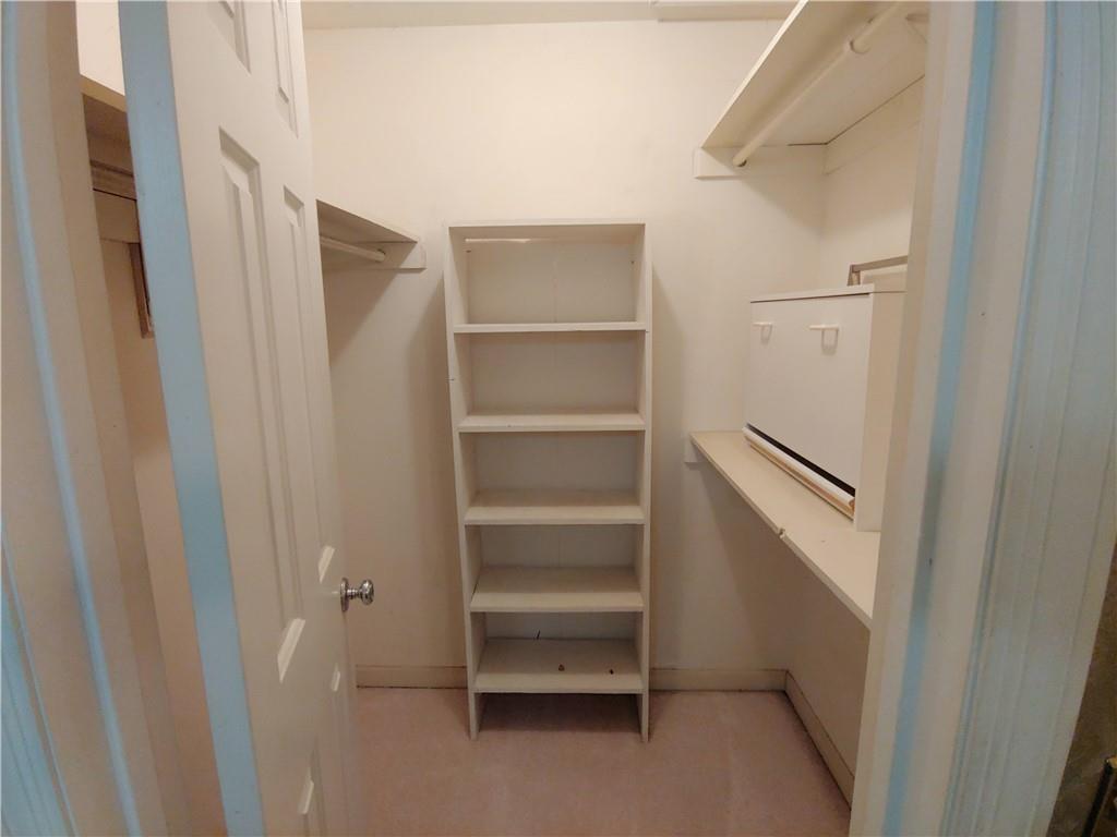 Walk in closet with shelving Walk in closet with shelving
