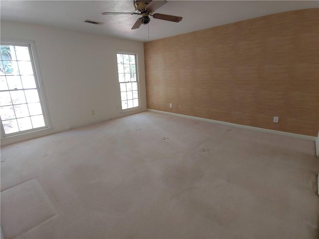 With plush light carpet and ceiling fan With plush light carpet and ceiling fan