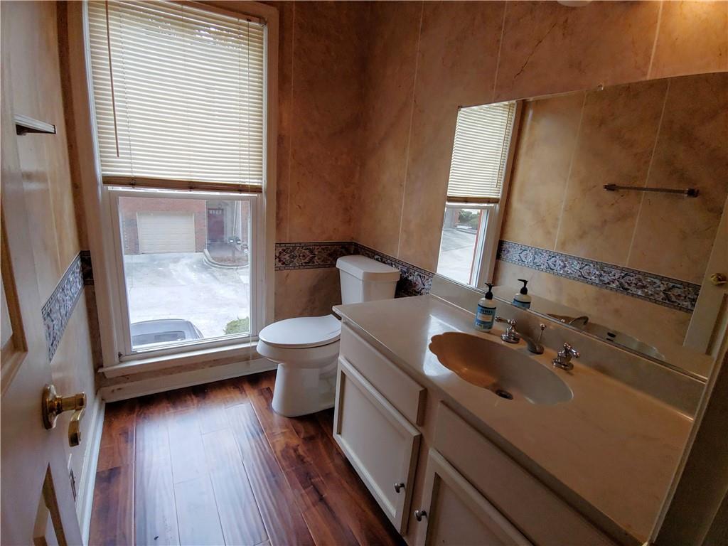 Half bathroom with hardwood flooring, and vanity Half bathroom with hardwood flooring, and vanity