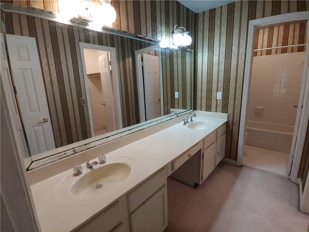 Master Bathroom with shower / bath combination, vanity with extensive cabinet space, and double sink Master Bathroom with shower / bath combination, vanity with extensive cabinet space, and double sink