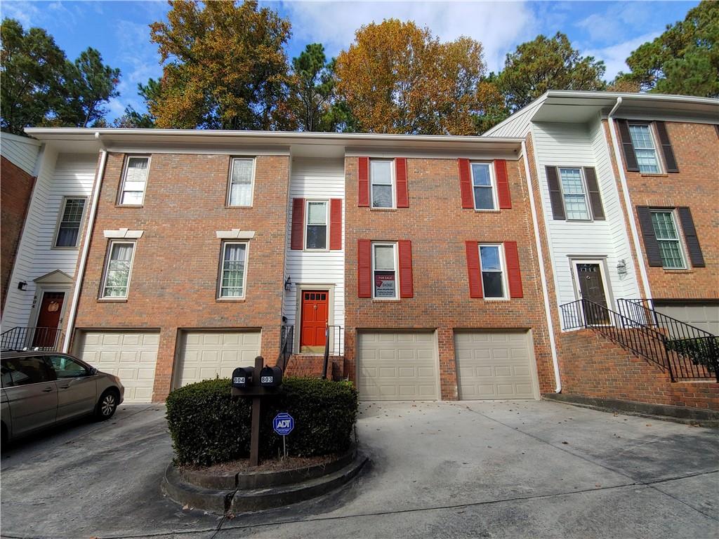 View of building exterior with a garage View of building exterior with a garage