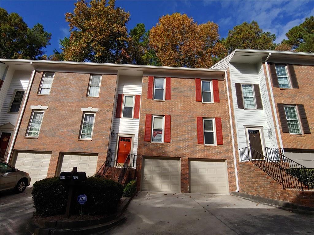 View of building exterior featuring a 2 car garage View of building exterior featuring a 2 car garage