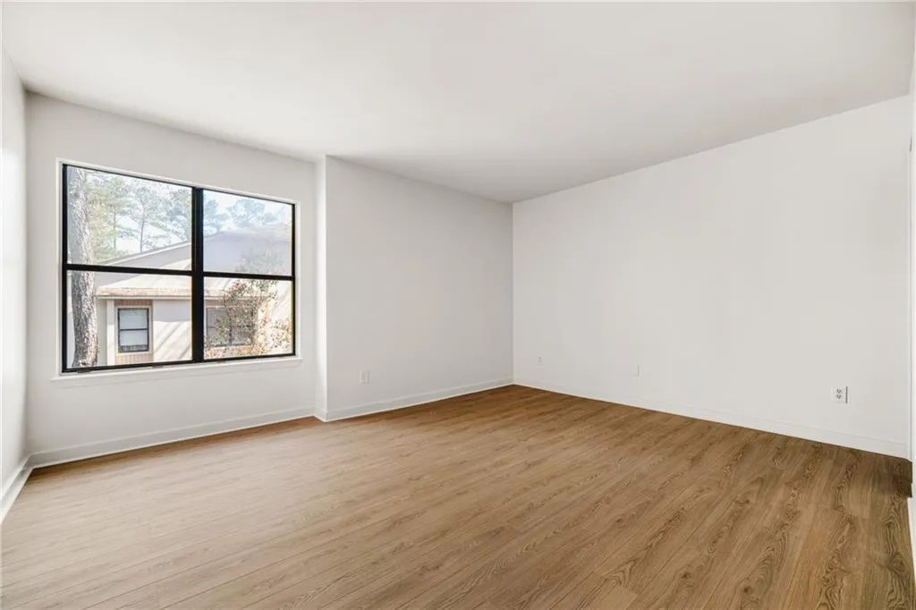 Unfurnished room with light wood finished floors and baseboards