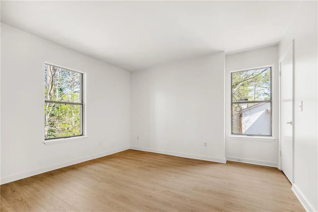 Unfurnished room with light wood finished floors and healthy amount of natural light