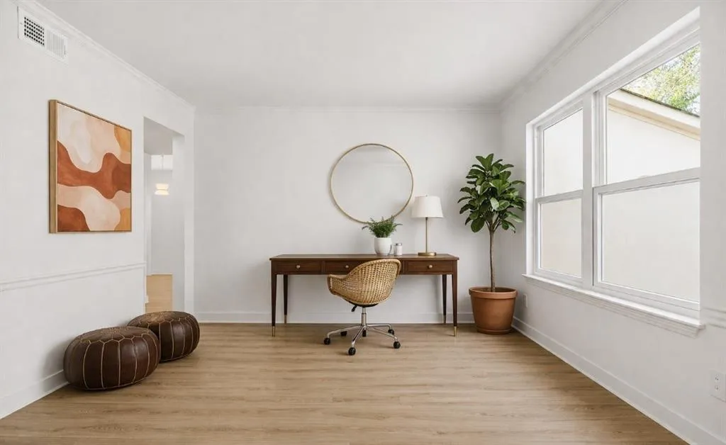 Office featuring light wood-type flooring and ornamental molding