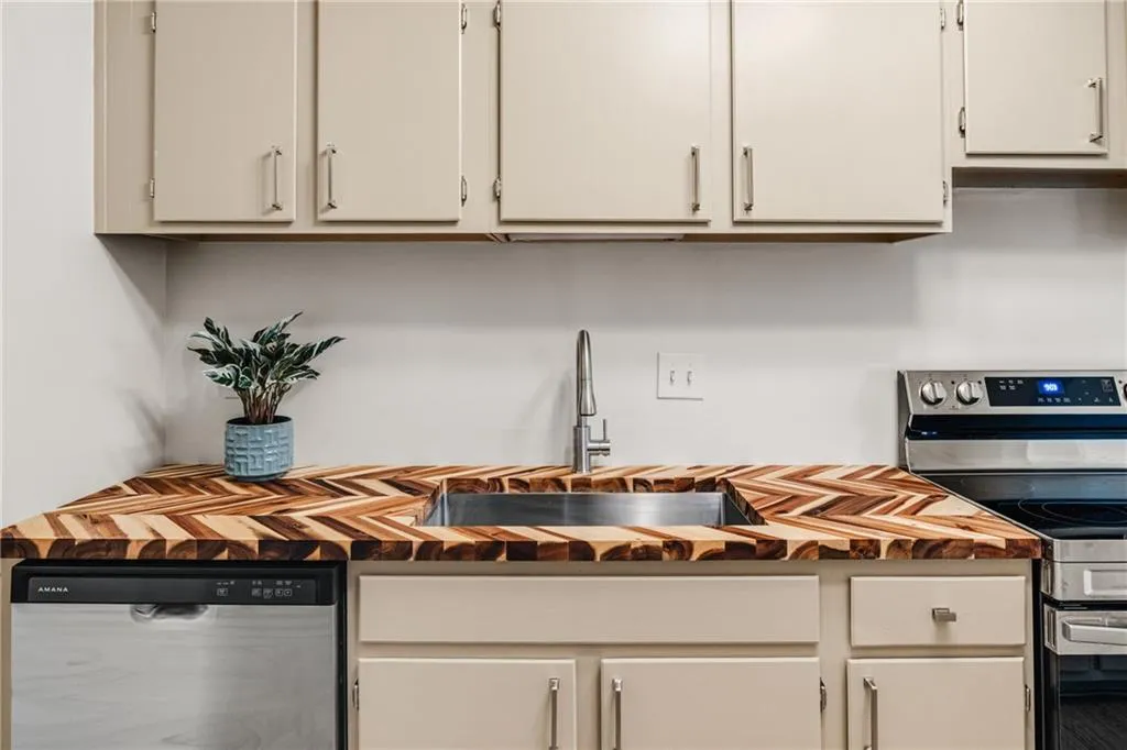 Kitchen featuring stainless steel appliances and butcher block countertops