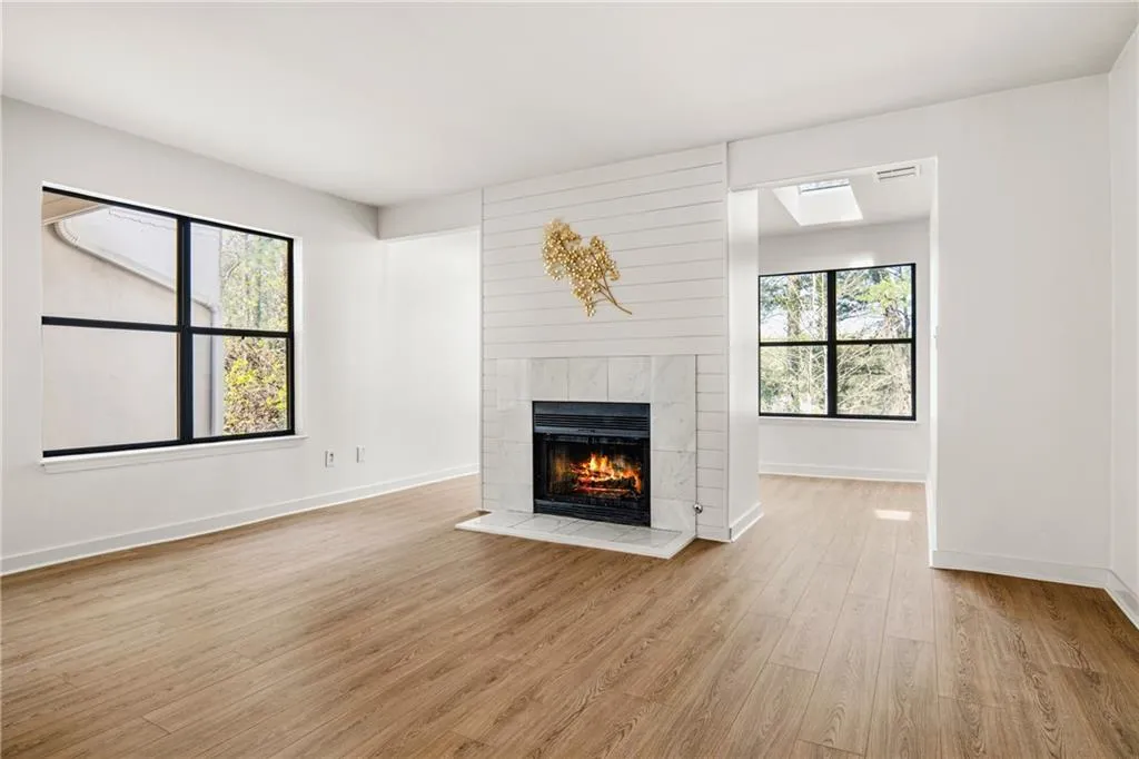 Unfurnished living room featuring light wood-type flooring and a fireplace