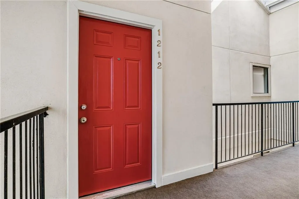 Entrance to property featuring stucco siding