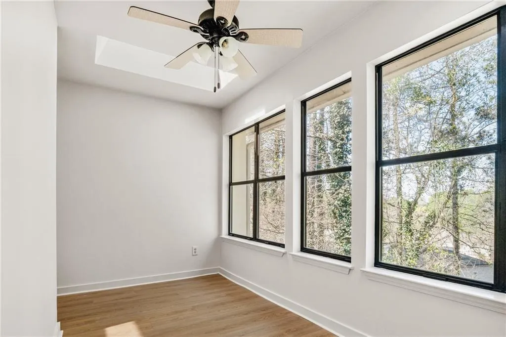 Unfurnished room featuring ceiling fan and light wood-style flooring