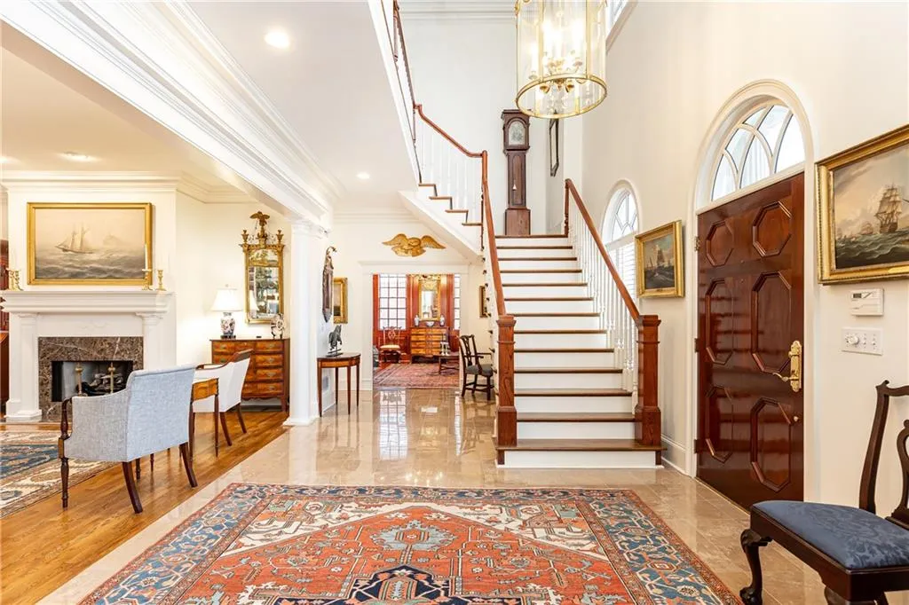 Two story foyer with sweeping staircase suggests and elegant classic.
