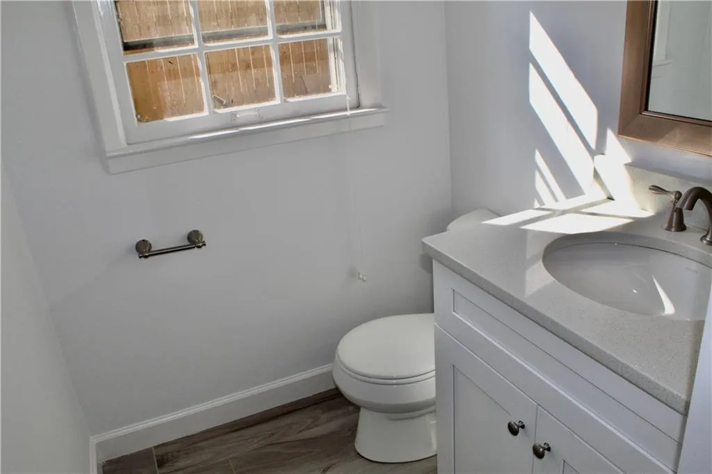 Half bathroom featuring plenty of natural light and vanity