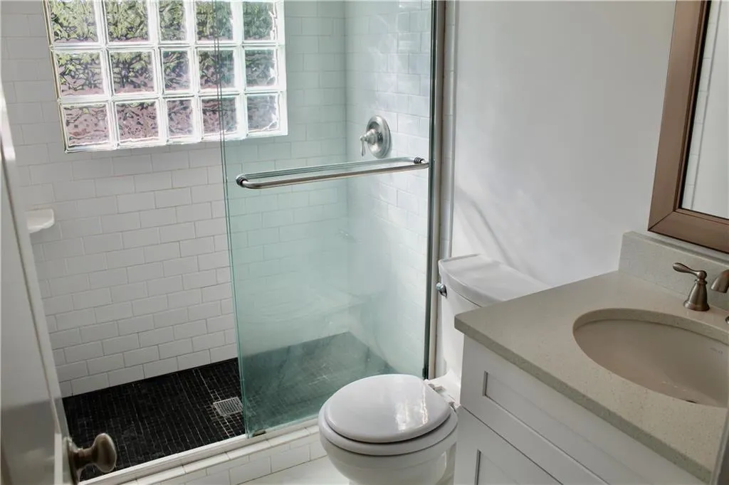 Bathroom with a stall shower and vanity