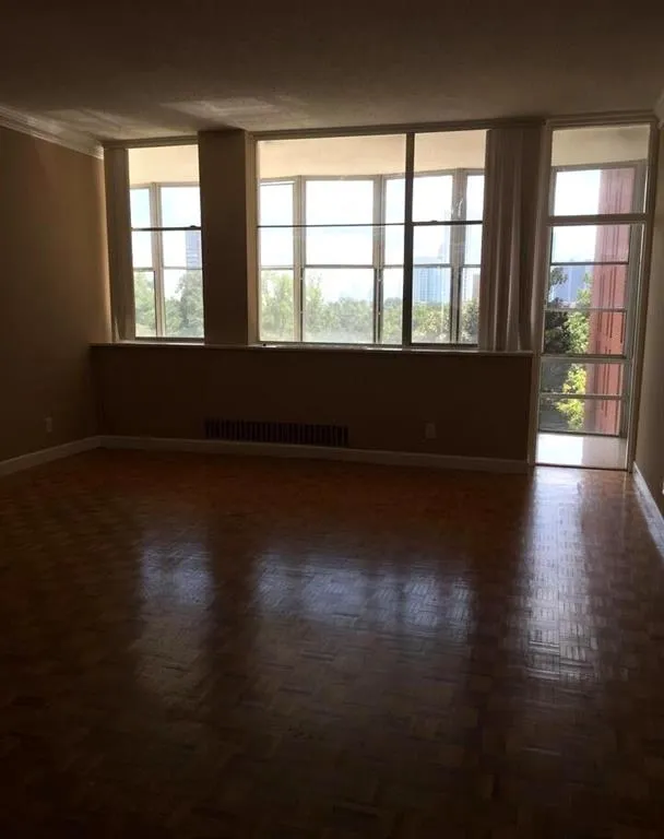 Spare room featuring baseboards and crown molding