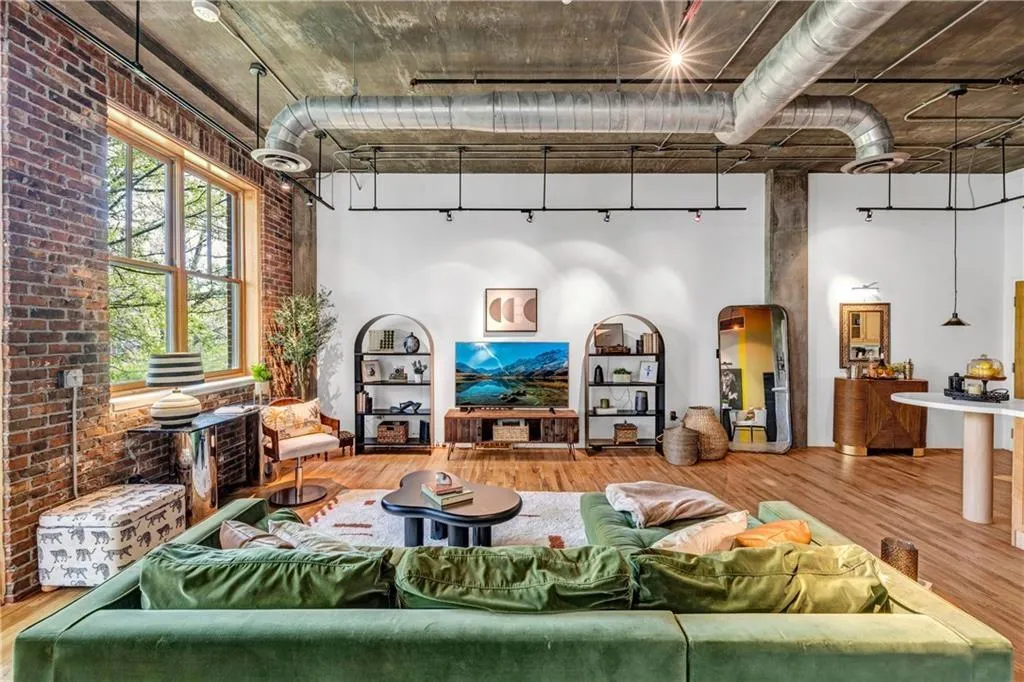 Living area featuring wood finished floors and brick wall