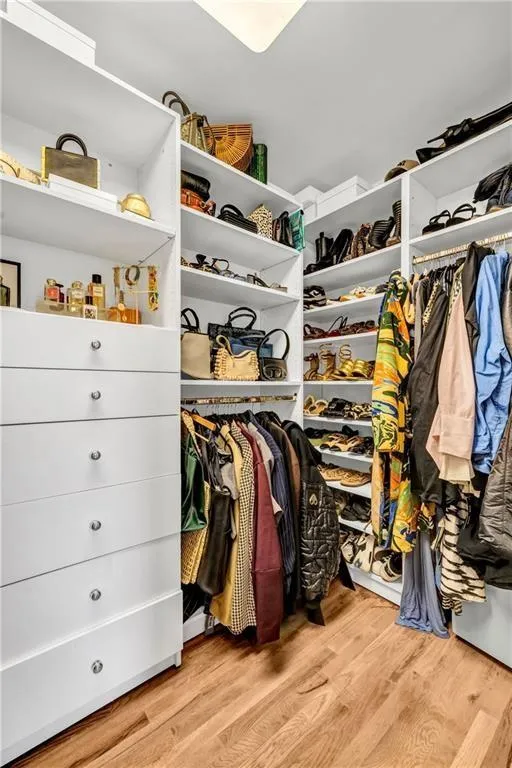 Spacious closet featuring light wood-type flooring