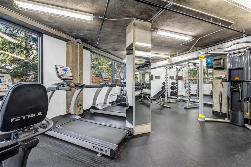 Exercise room featuring healthy amount of natural light and concrete block wall