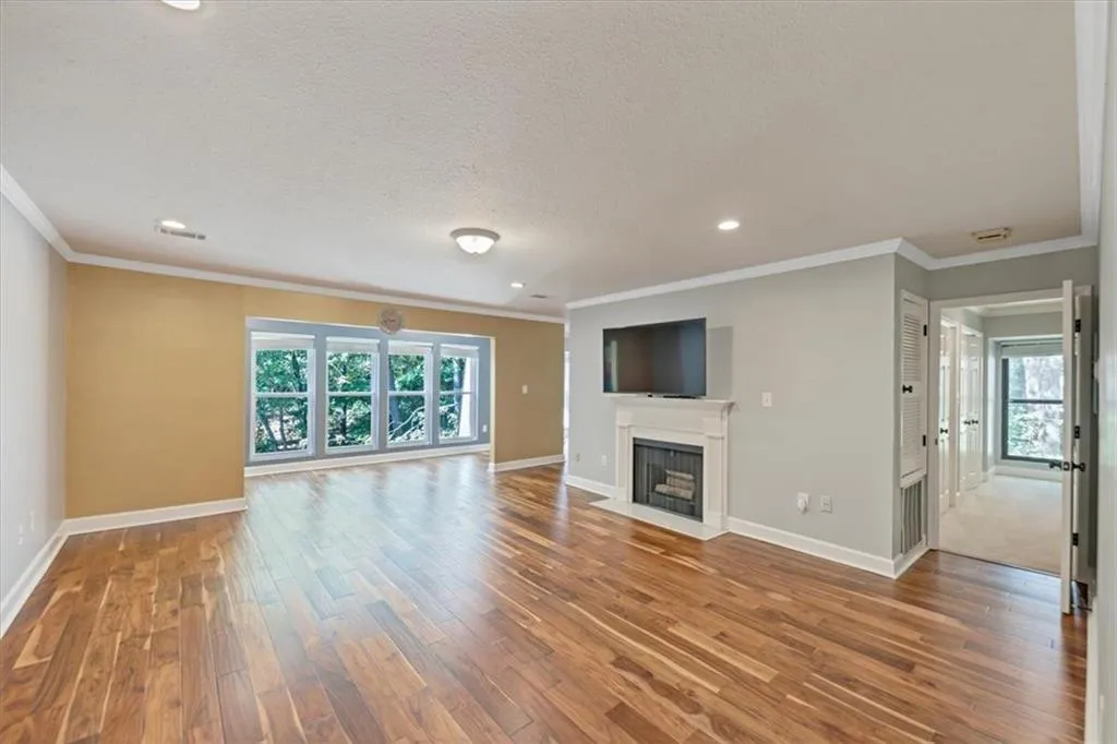Your bright, beautiful,  open fireside living room with fantastic wood floors, wall of windows brings in fabulous light from your sunroom