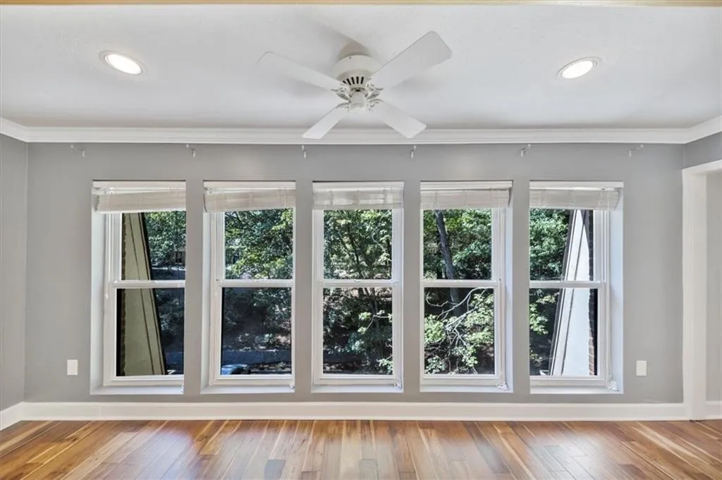 Sunroom wall of windows brings in bright light. Great space as your office, reading room or for your plants