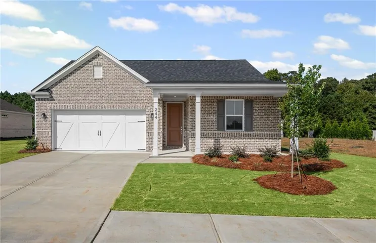 **Photos are not of actual home.** View of front facade with covered porch, brick siding, driveway, and a front yard