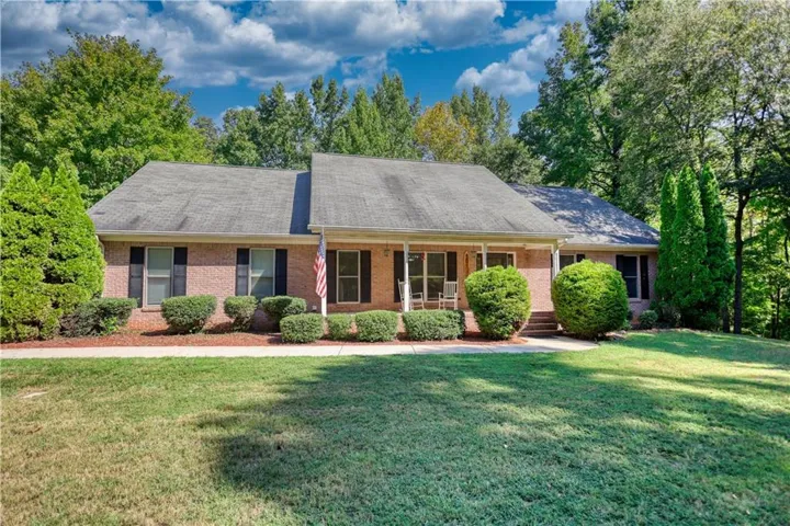 Brick exterior with a covered front porch and a paved walkway
