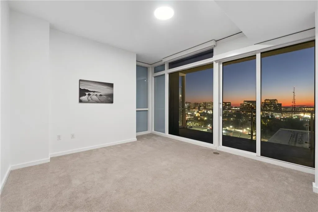 Empty room with carpet and baseboards