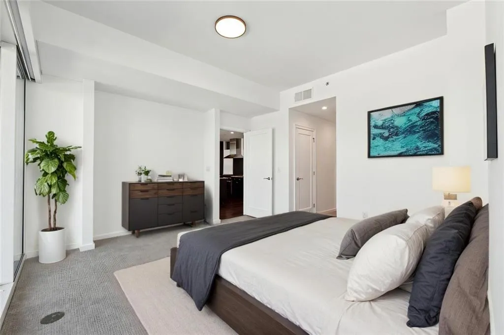 Bedroom featuring baseboards, visible vents, and light colored carpet