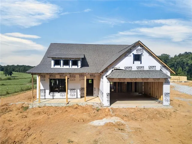 Gable roofline, prominent dormer window, covered front entry, attached garage structure, new construction
