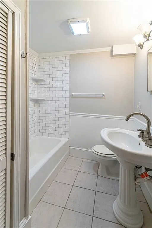 Full bathroom featuring tile patterned flooring, a closet, and shower / washtub combination