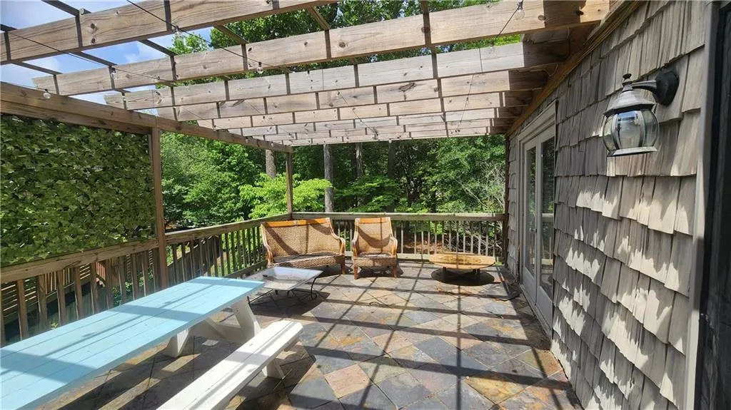 View of patio featuring a pergola and an outdoor hangout area
