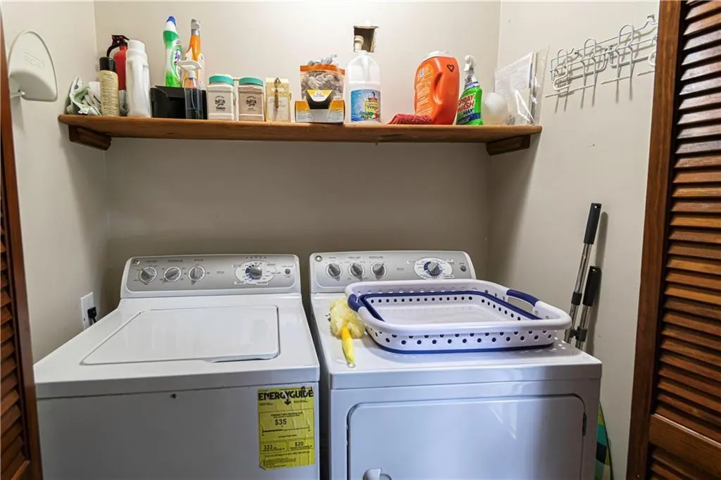 Laundry room with washer and clothes dryer