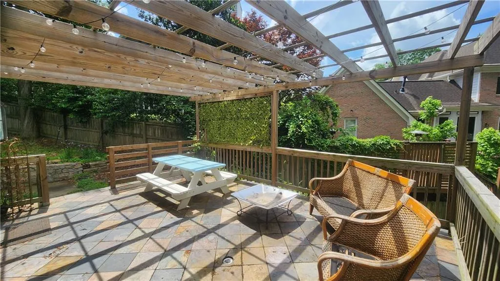 Fenced backyard featuring outdoor dining area, a pergola, and a patio