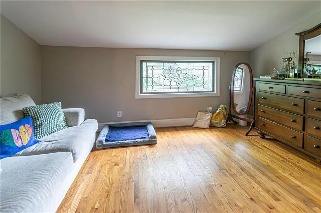 Sitting room featuring light wood-type flooring and plenty of natural light