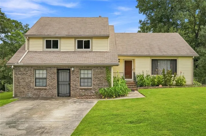 Brick and siding exterior with a shingled roof