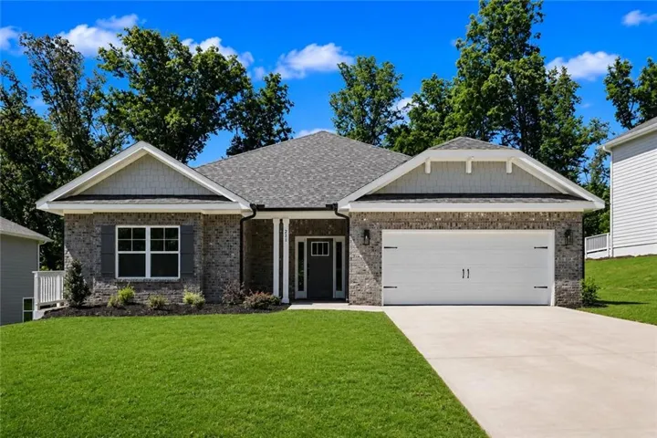 The beautiful 1902 plan is a 4/2 ranch, brick exterior with gabled roof lines, attached two-car garage, concrete driveway, and front landscaping.
